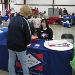 Pam with Centennial Bank visits with folks