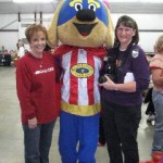 Safty pup for kids takes time out for a picture with Pat Reeves and Lori Freeze with the Stone County Leader